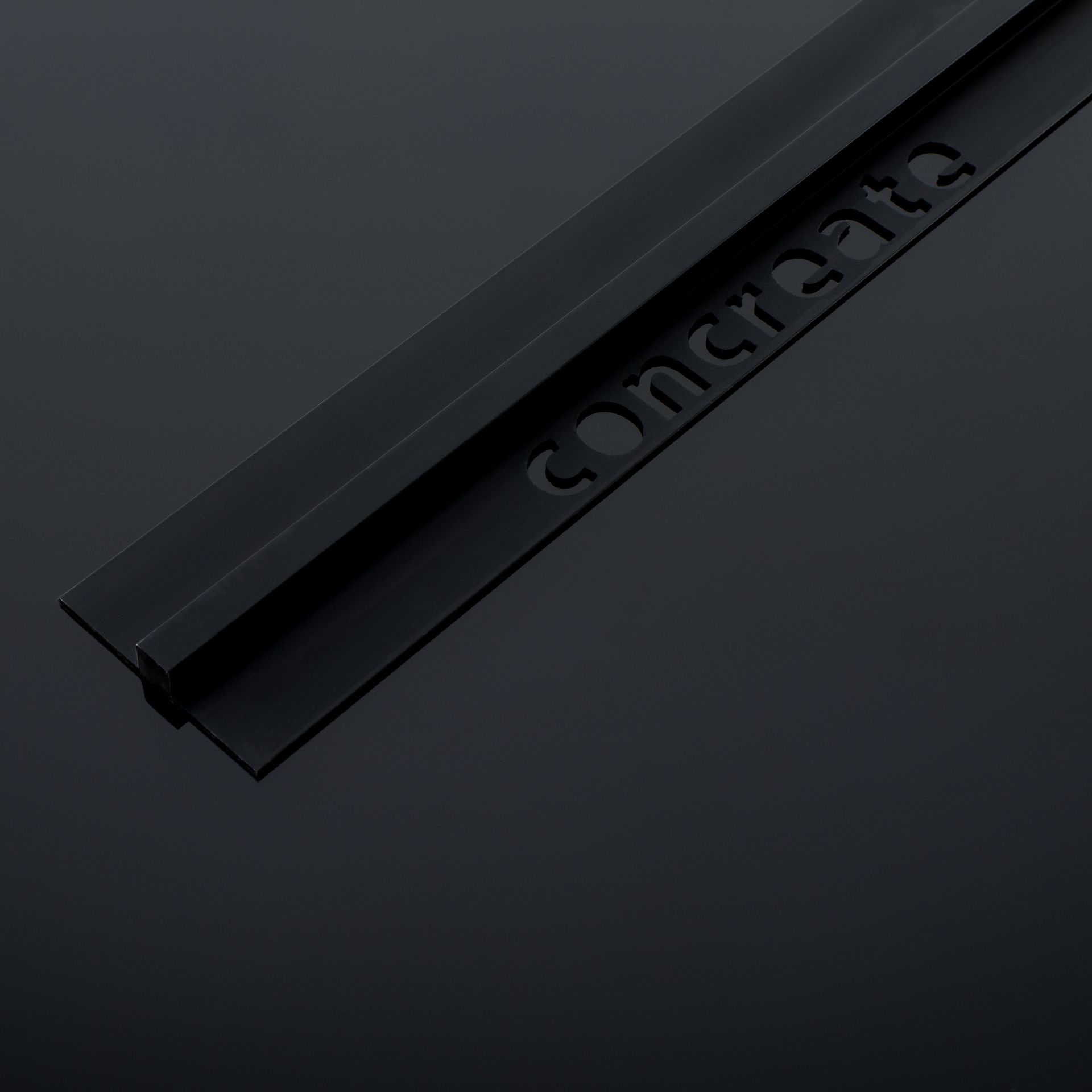 a black piece of plastic with the word concrete written on it .