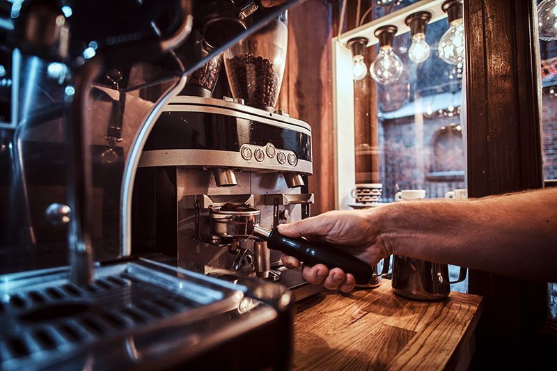 Barista preparing fresh coffee at Hollyhocks Coffee House