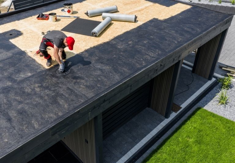Drill on a dark surface with checkered pattern, likely for construction.