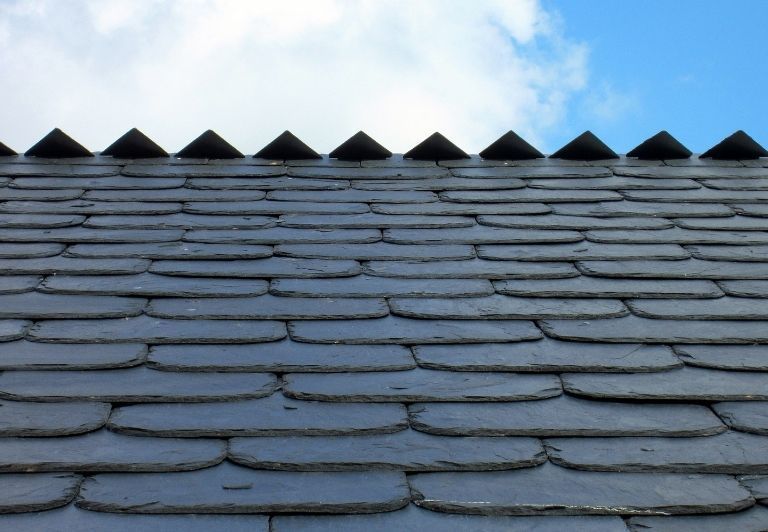 Gray slate roof tiles arranged in a staggered pattern.