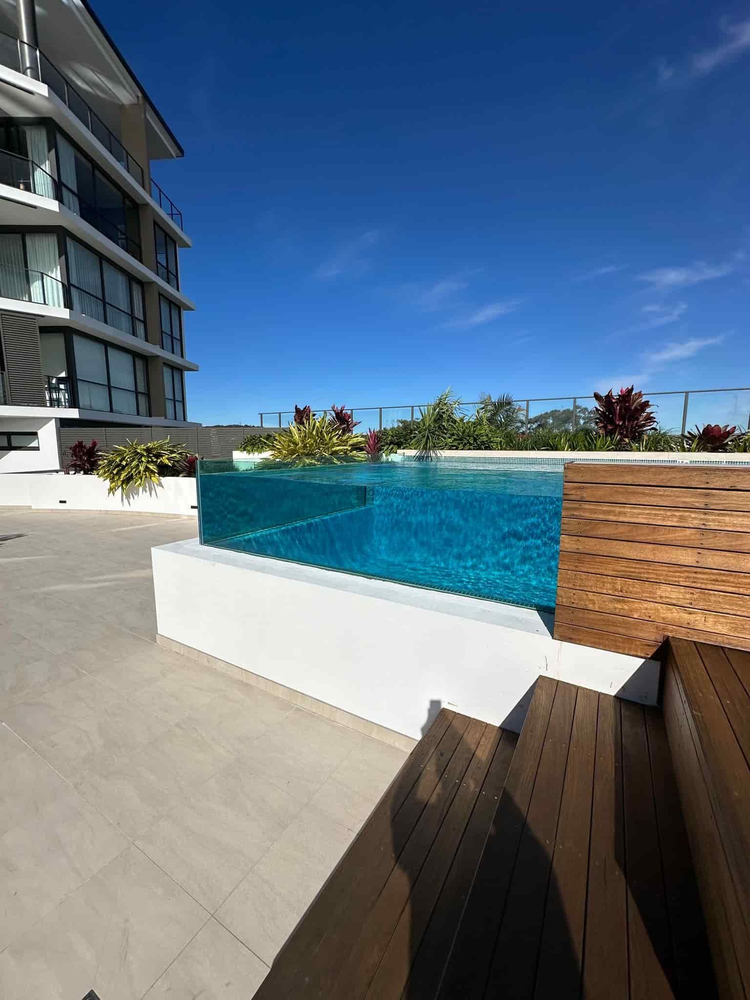 A Pool With Glass Sides and a Modern Building — Glass Pool Windows Australia In Dee Why, NSW