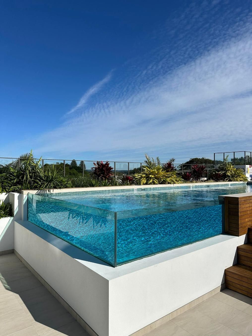 A Large Swimming Pool With A Clear Glass Surround — Glass Pool Windows Australia In Old Bar, NSW