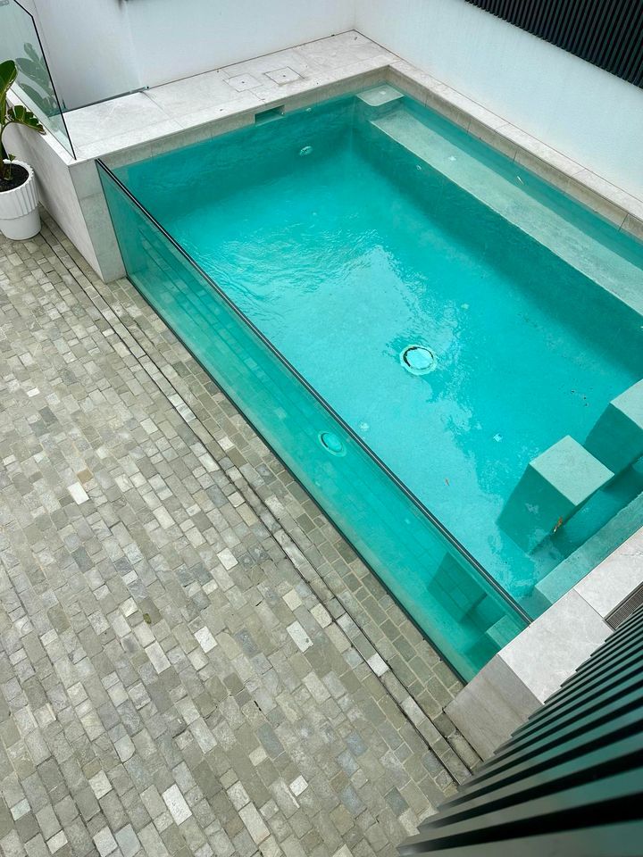 A Swimming Pool With Clear Glass Walls And Steps — Glass Pool Windows Australia In Old Bar, NSW