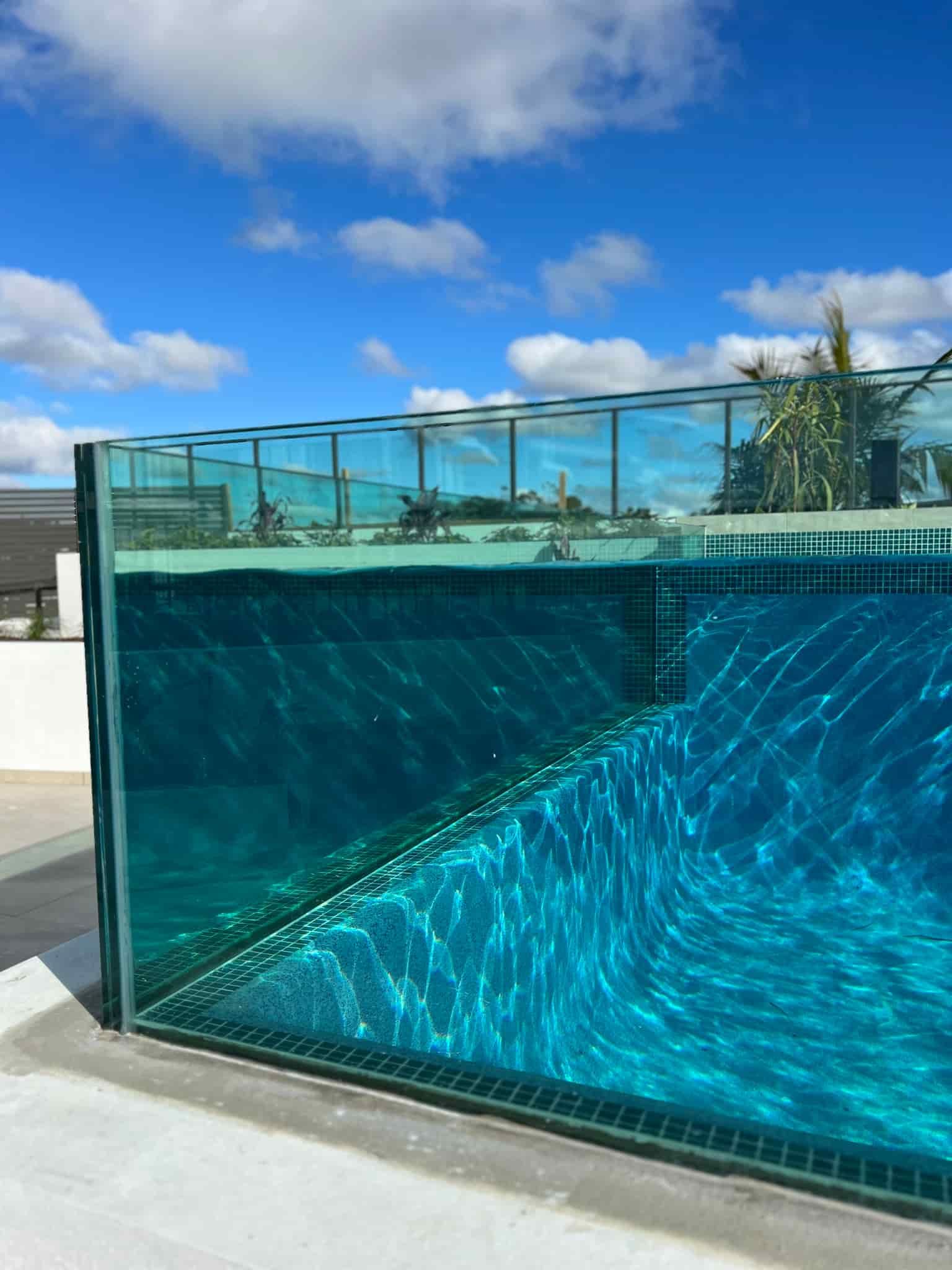 A Glass-walled Pool Reflecting a Clear Blue Sky — Glass Pool Windows Australia In Burleigh Heads, QLD