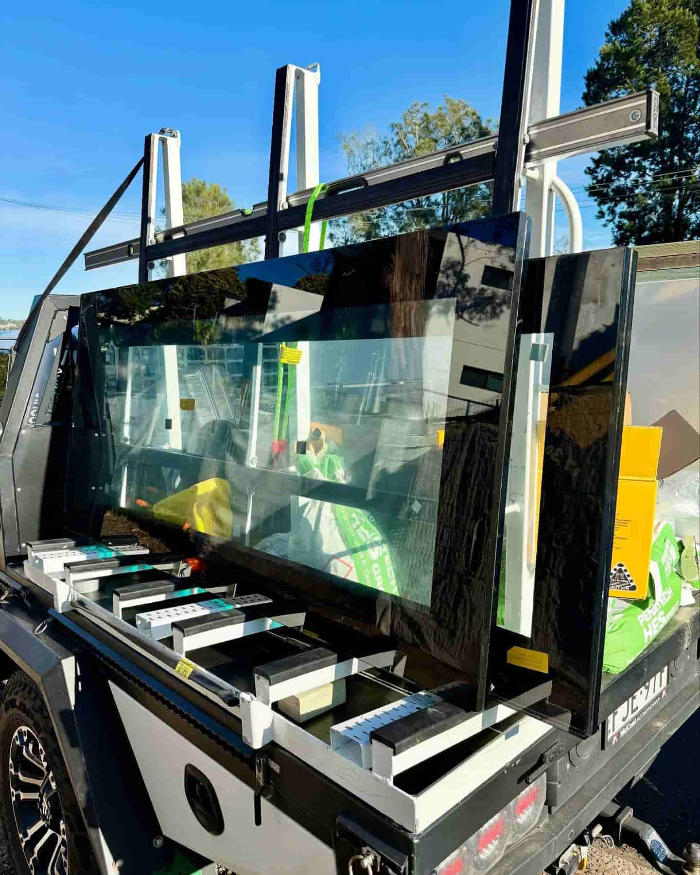 Large Panes of Black Glass Secured to a Truck Bed — Glass Pool Windows Australia In Surfers Paradise, QLD
