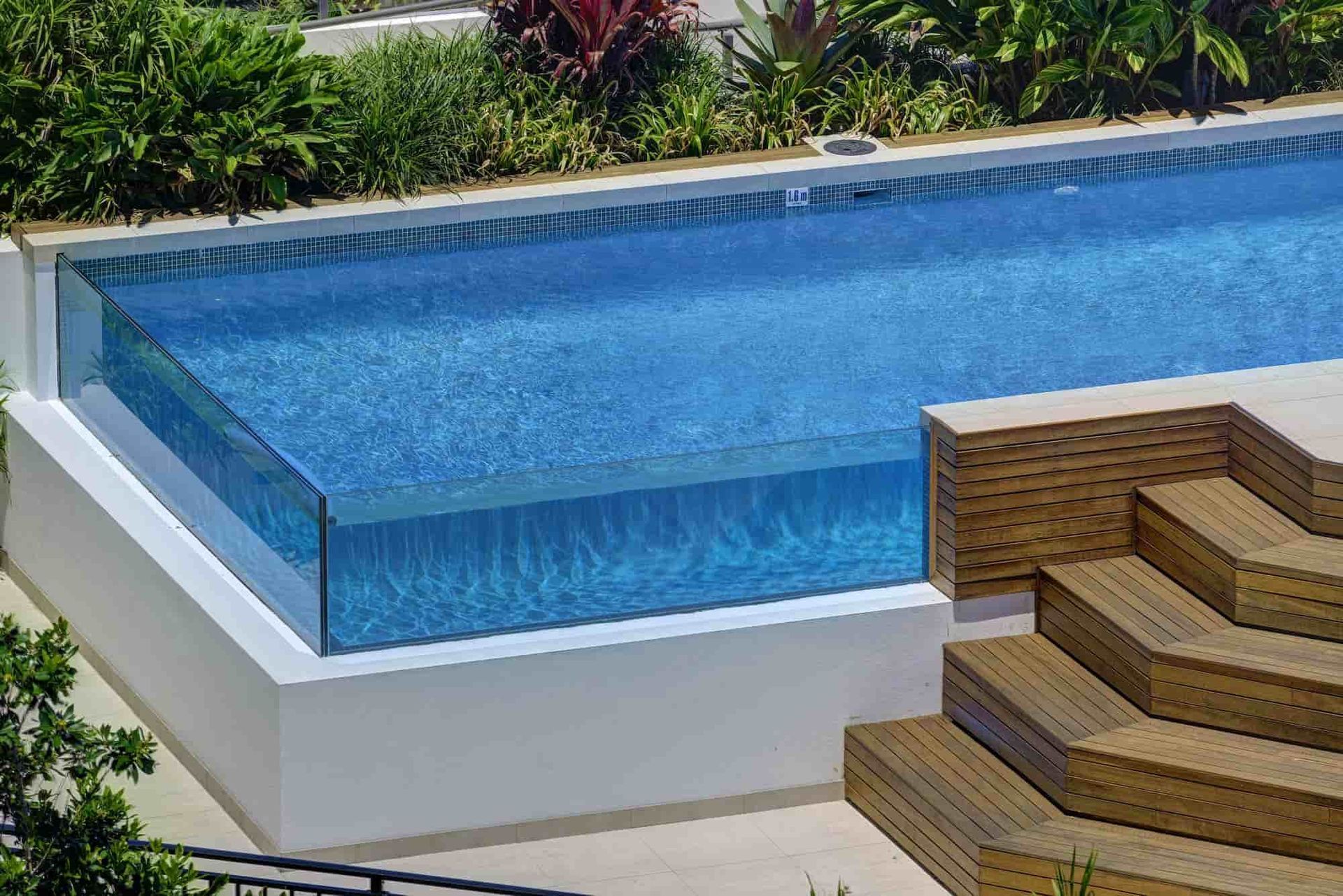 A Rectangular Swimming Pool With Clear Glass Sides — Glass Pool Windows Australia In Palm Beach, QLD