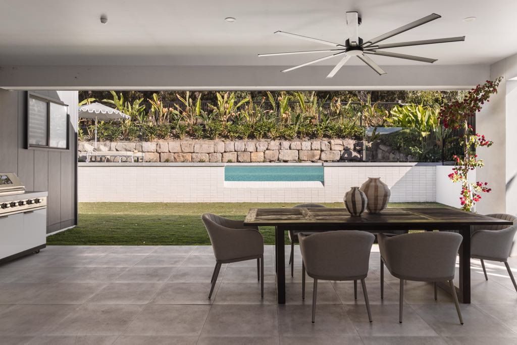 Outdoor Dining Area With a Table, Chairs, and a Pool — Glass Pool Windows Australia In Bondi, NSW