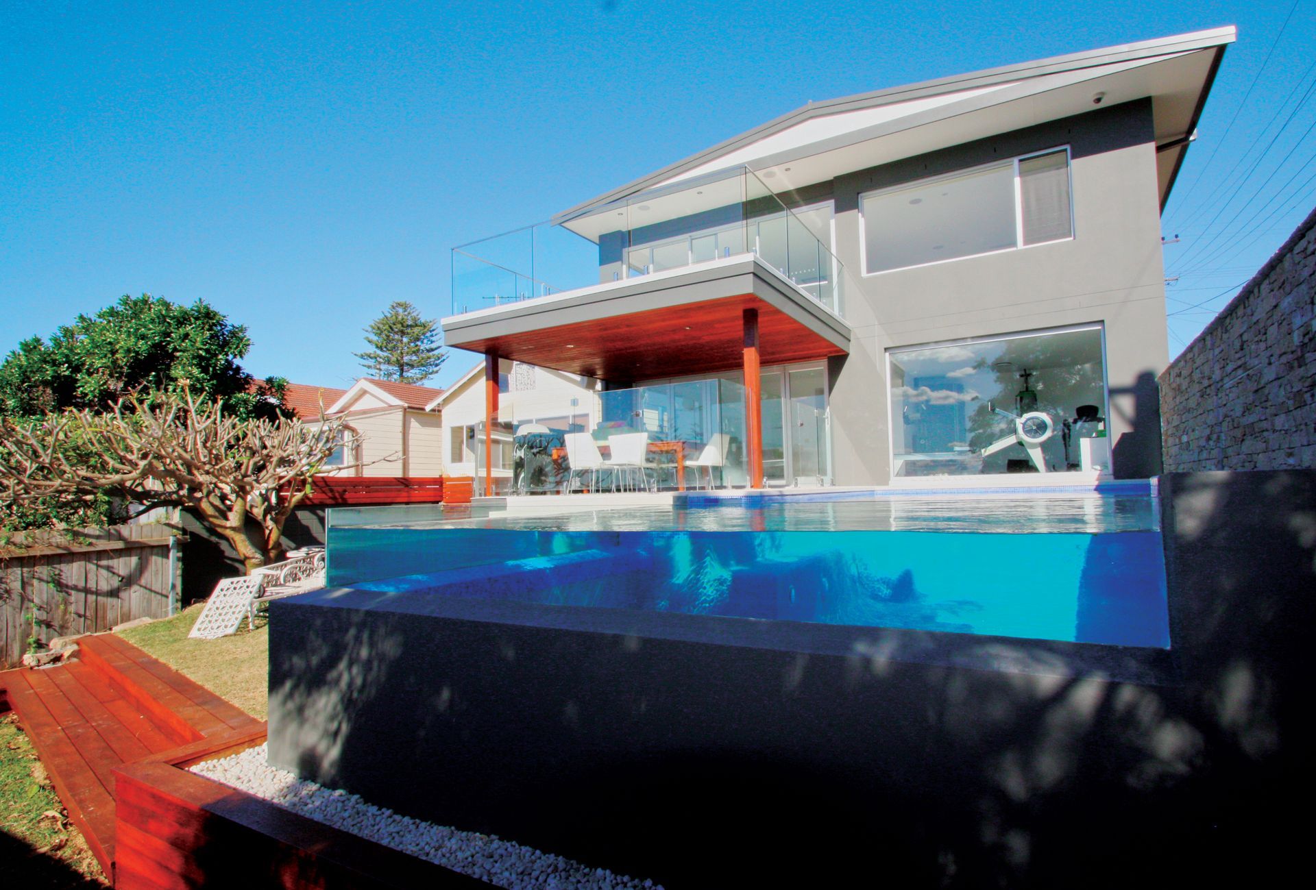 A House With A Swimming Pool In Front Of It — Glass Pool Windows Australia In Old Bar, NSW