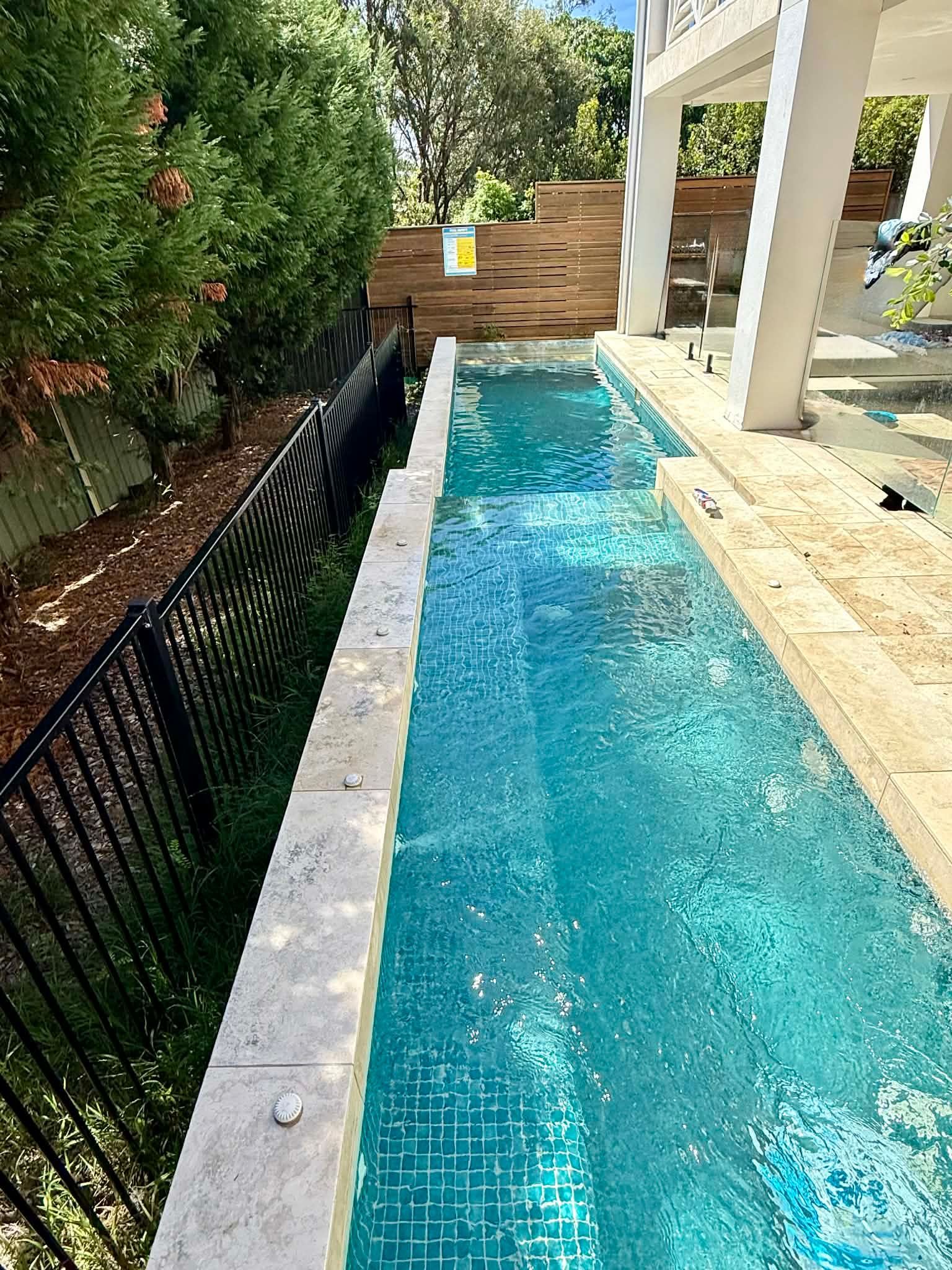 A Narrow, Rectangular Lap Pool With Blue Mosaic Tiles — Glass Pool Windows Australia In Nabiac, NSW