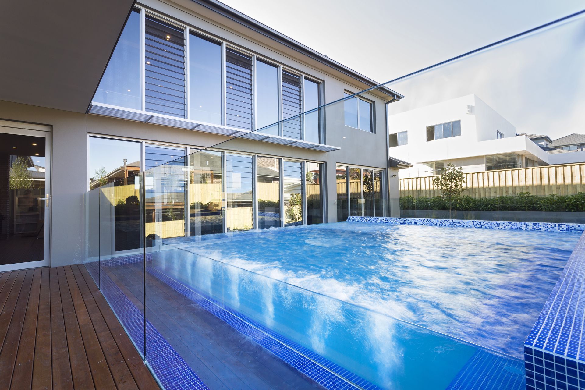 A Modern Two-story Home With a Blue-tiled Swimming Pool — Glass Pool Windows Australia In Nabiac, NSW