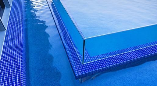 A Close Up Of A Swimming Pool With Blue Tiles And Steps — Glass Pool Windows Australia In Sydney, NSW