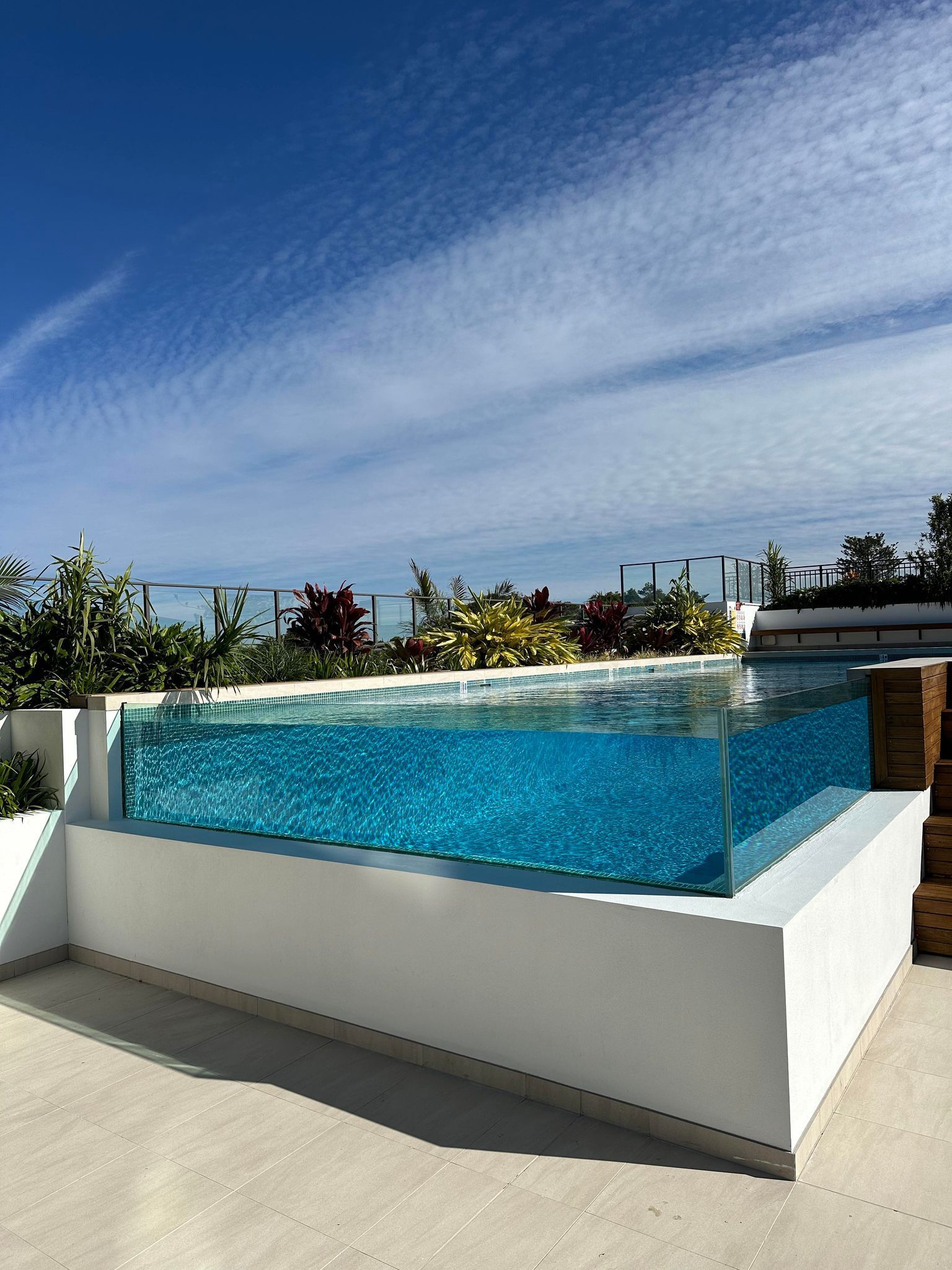 A Large Swimming Pool With A Clear Glass Bottom — Glass Pool Windows Australia In Old Bar, NSW