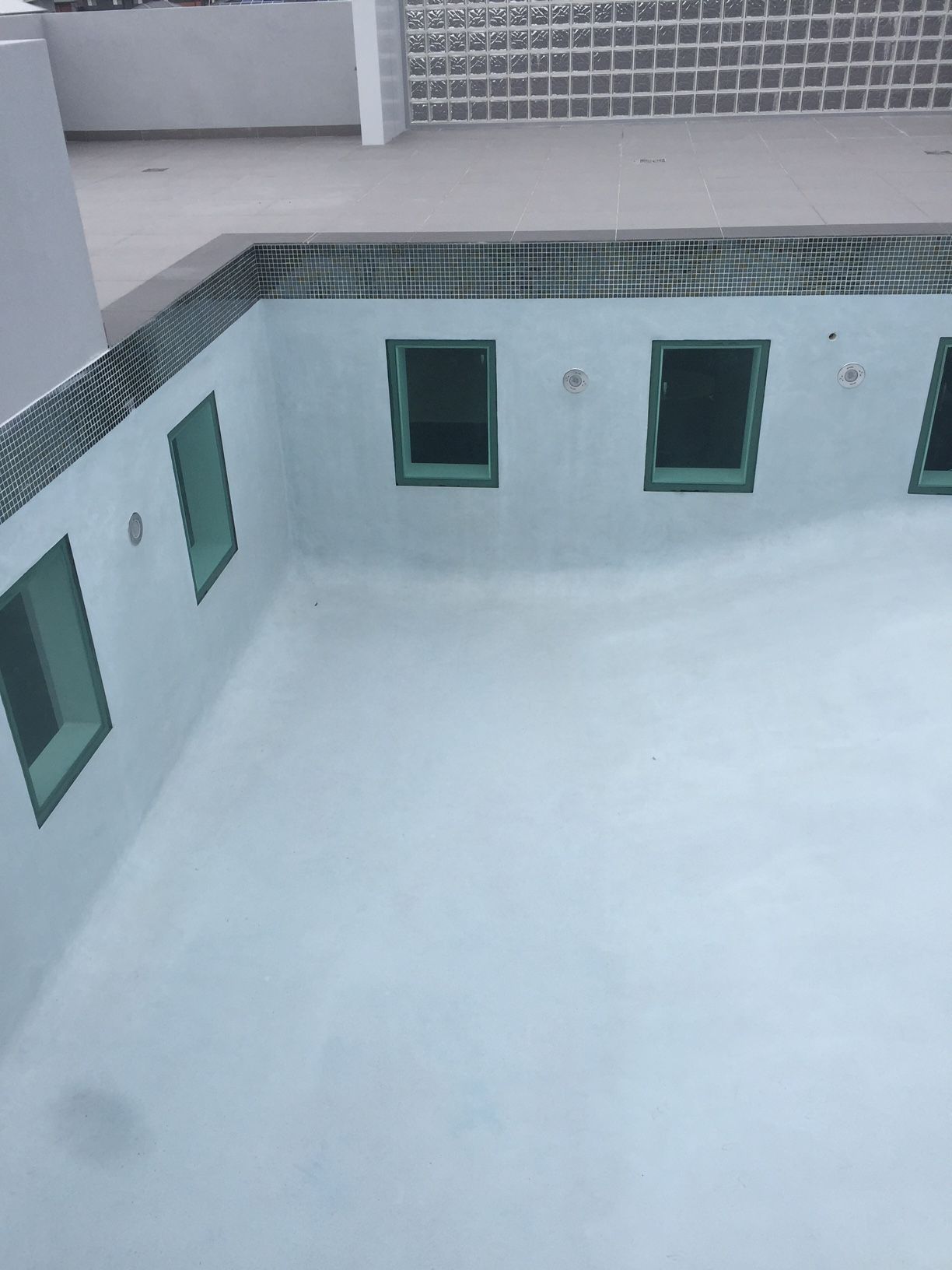 A Swimming Pool With A Lot Of Windows In It — Glass Pool Windows Australia In Brisbane, QLD