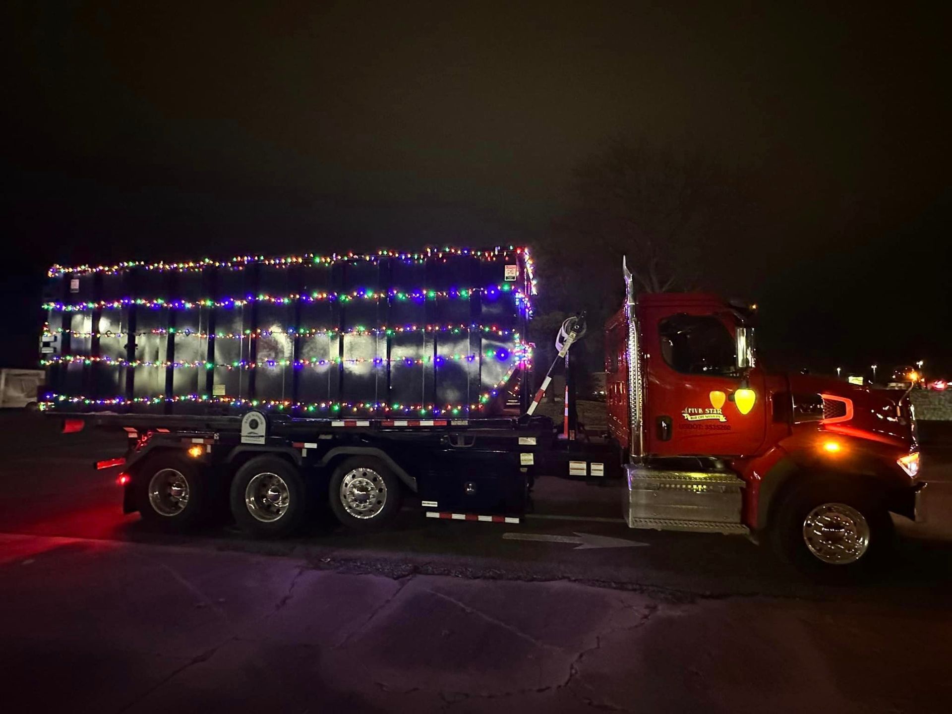 Red Truck Decorated with Christmas Lights at Night — Oktaha, OK — Five Star Roll-Offs Services