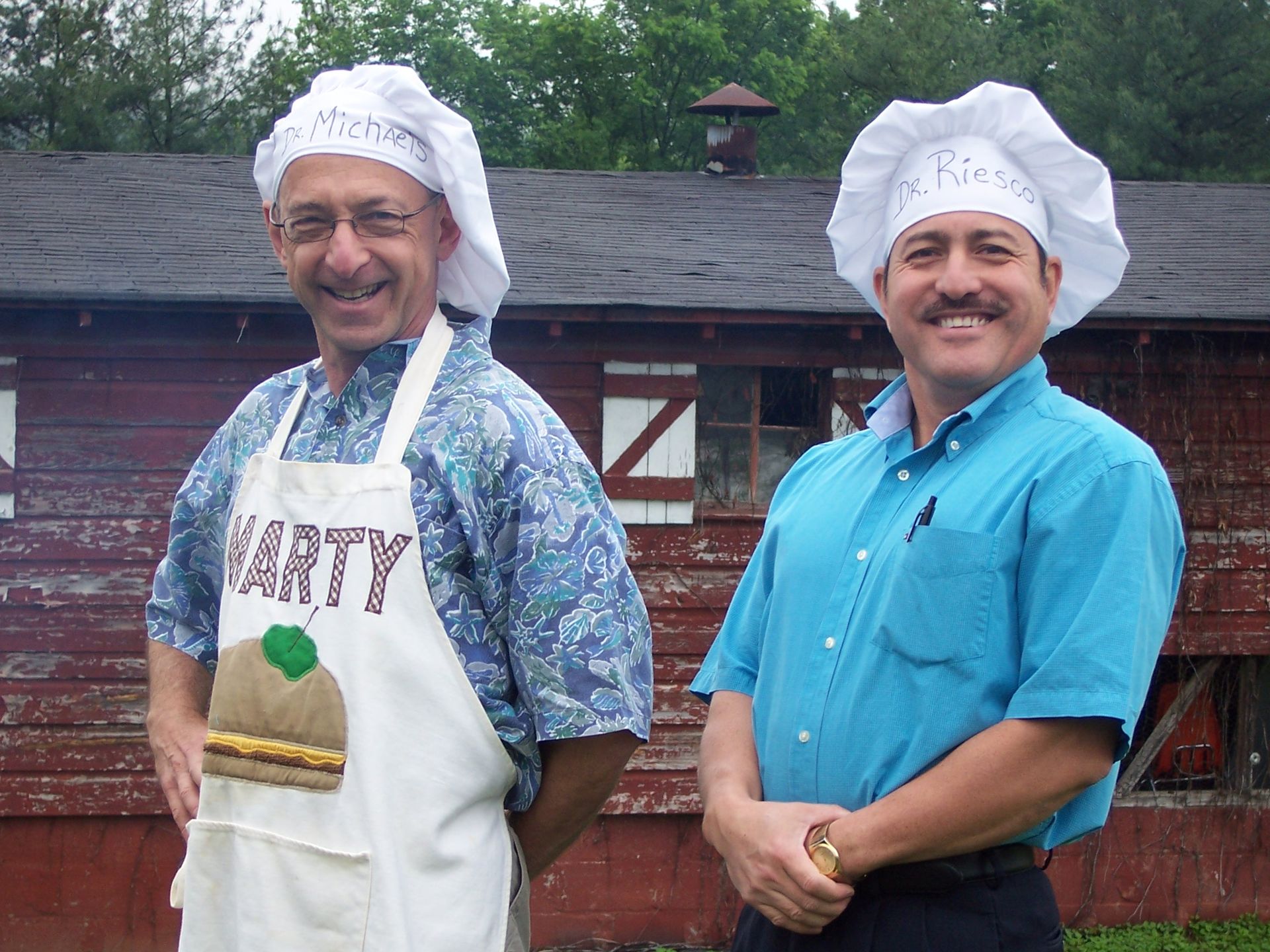 Two men wearing chef hats and aprons that say variety