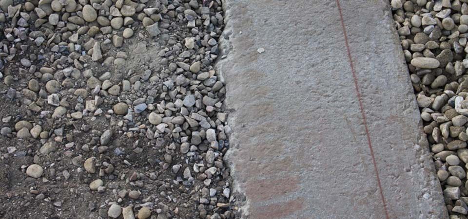 concrete walkway next to gravel
