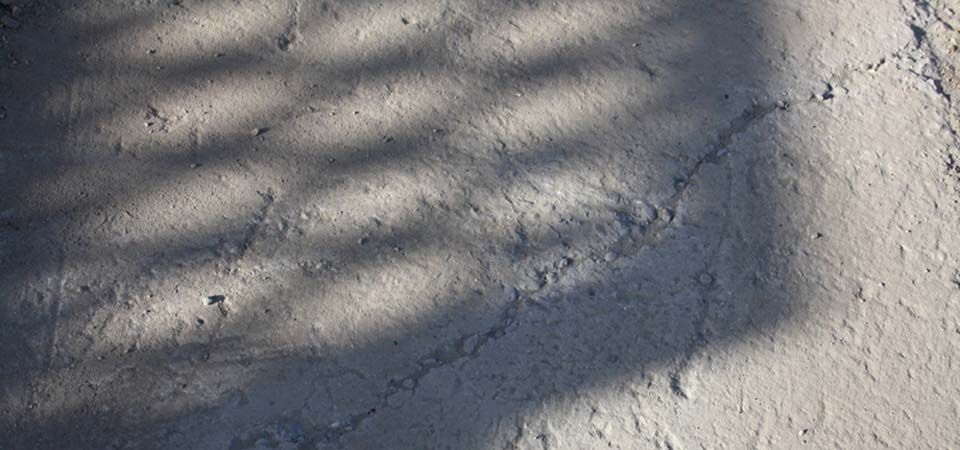 closeup of grey cracked concrete wall
