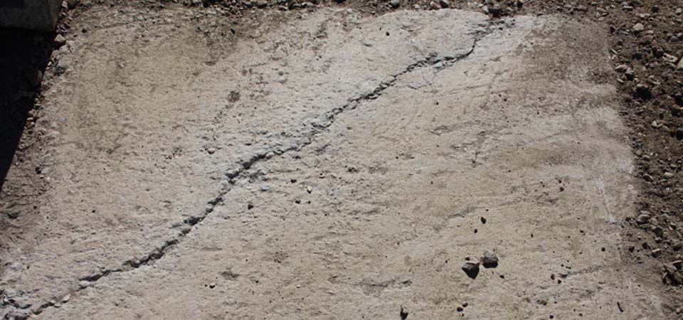 closeup of cracked beige concrete