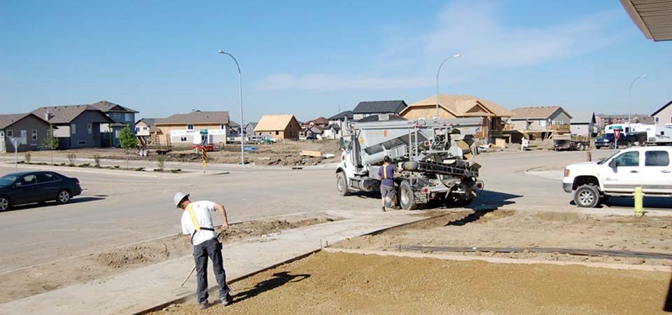 worker preparing residential front yard in perparation for landscaping job