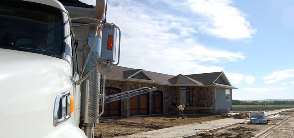 large dirt truck with preparing home for landscaping job