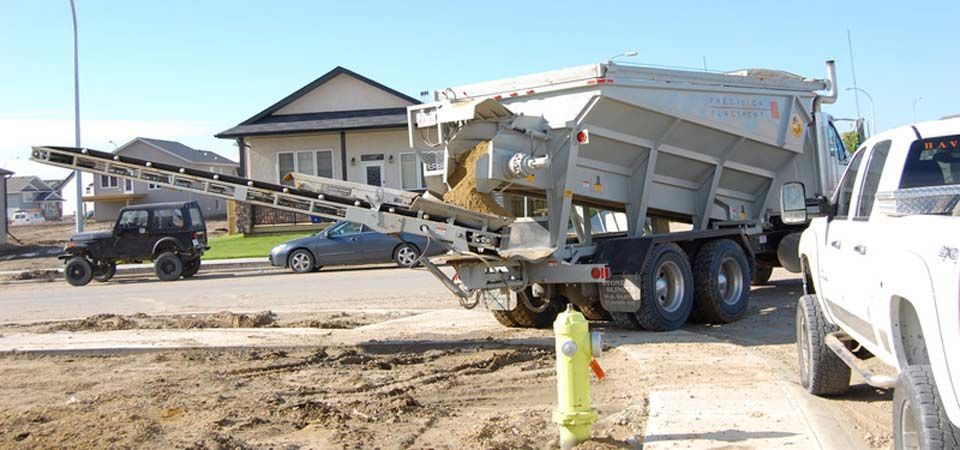 large white dirt truck and conveyer belt