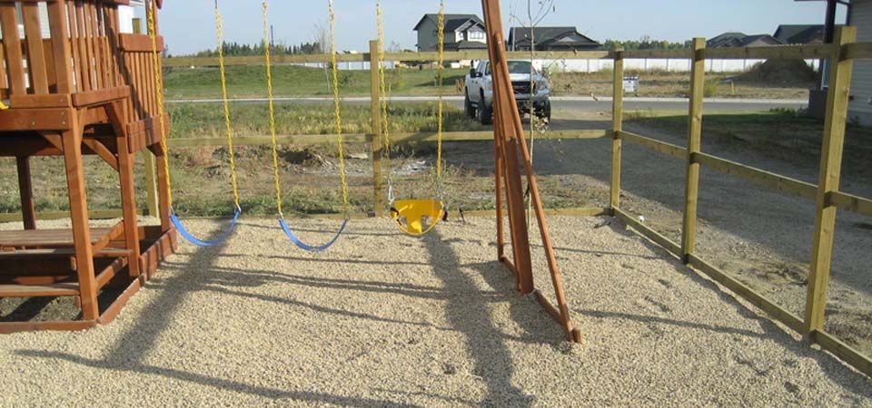 backyard swingset over gravel floor