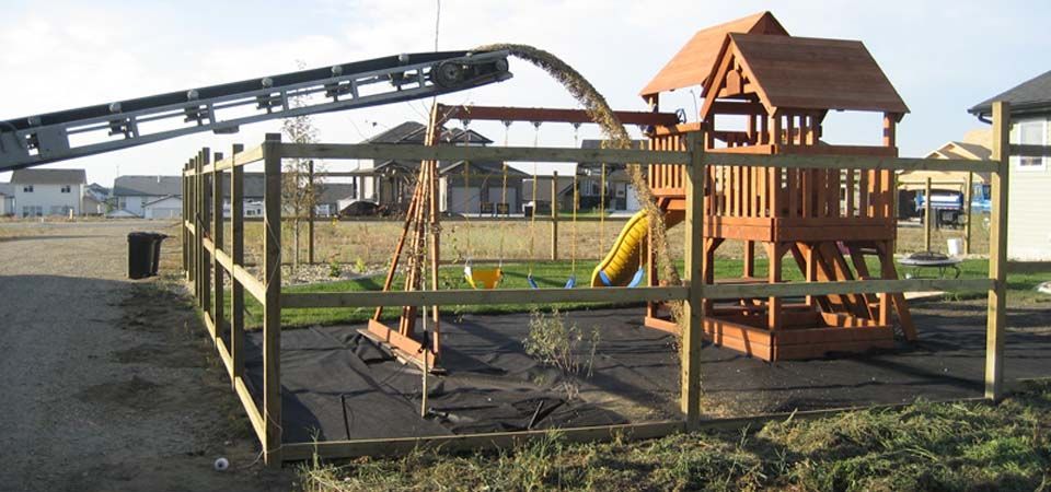 truck pouring dirt for the construction of swing set