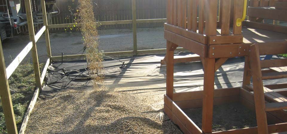 dirt being poured for swing set installation