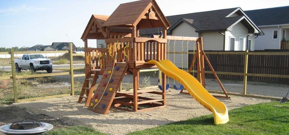 backyard wooden swingset with yellow slide