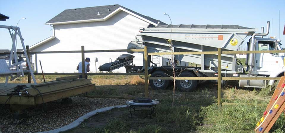 large grey dirt truck and landscaping job