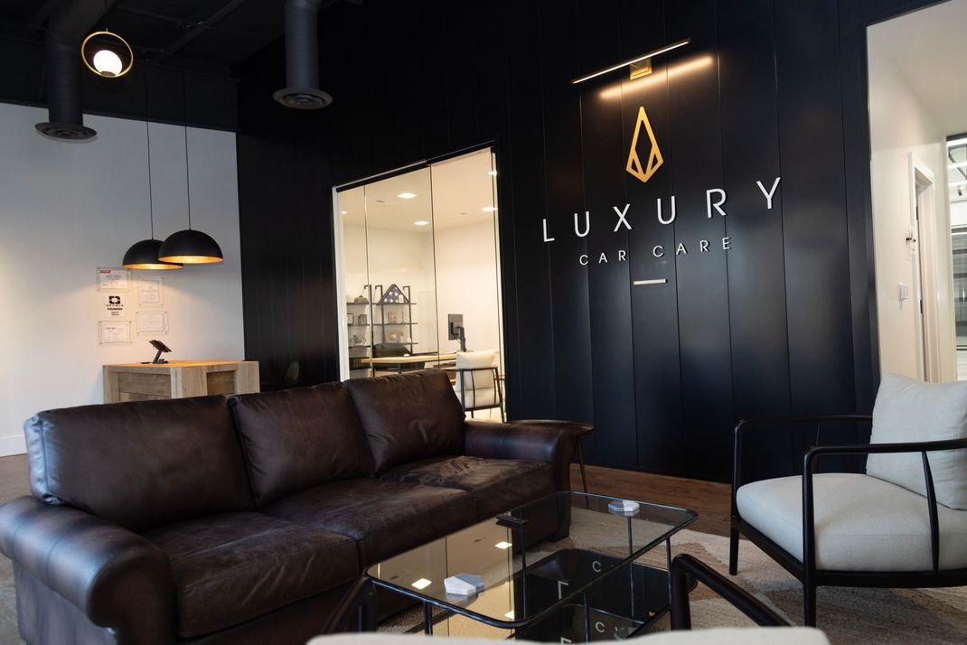 a living room with a couch and chairs and a sign that says luxury