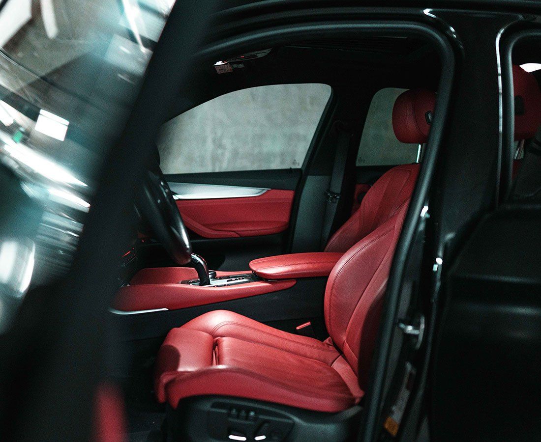 a black car with red seats and a steering wheel