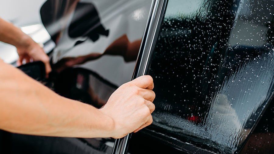 window tinting installation on a black car