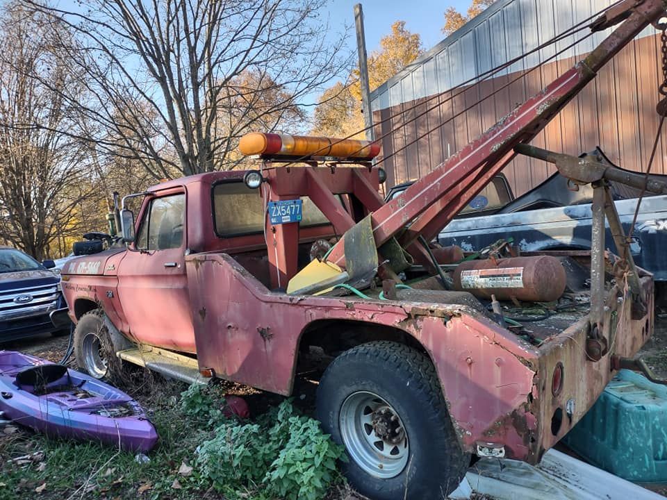 a red tow truck is parked in front of a building .