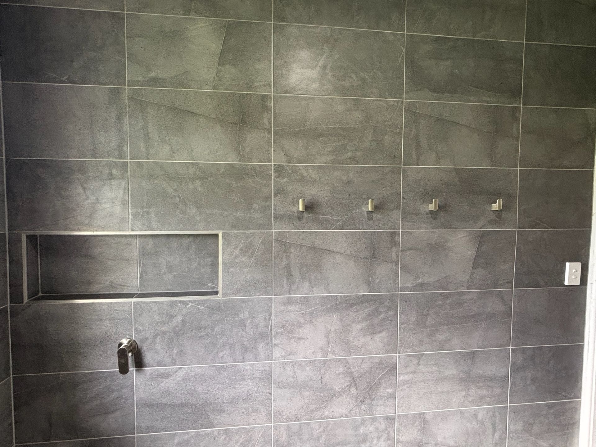Gray Tiled Shower Wall With Recessed Shelf — Edmonds Bathroom Renovations & Tiling In Laurieton, NSW