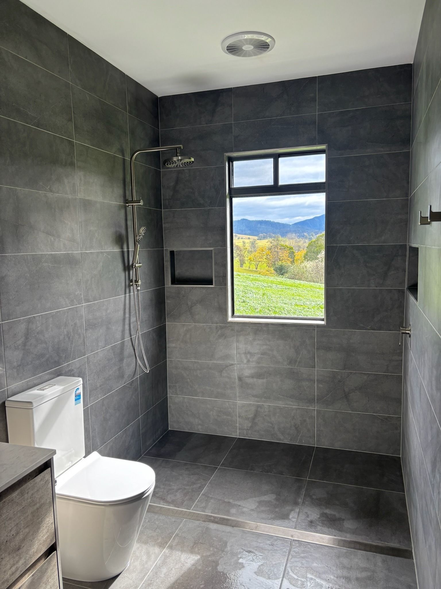 Bathroom With Dark Gray Tile Walls and Floor, Window — Edmonds Bathroom Renovations & Tiling In Lake Cathie, NSW