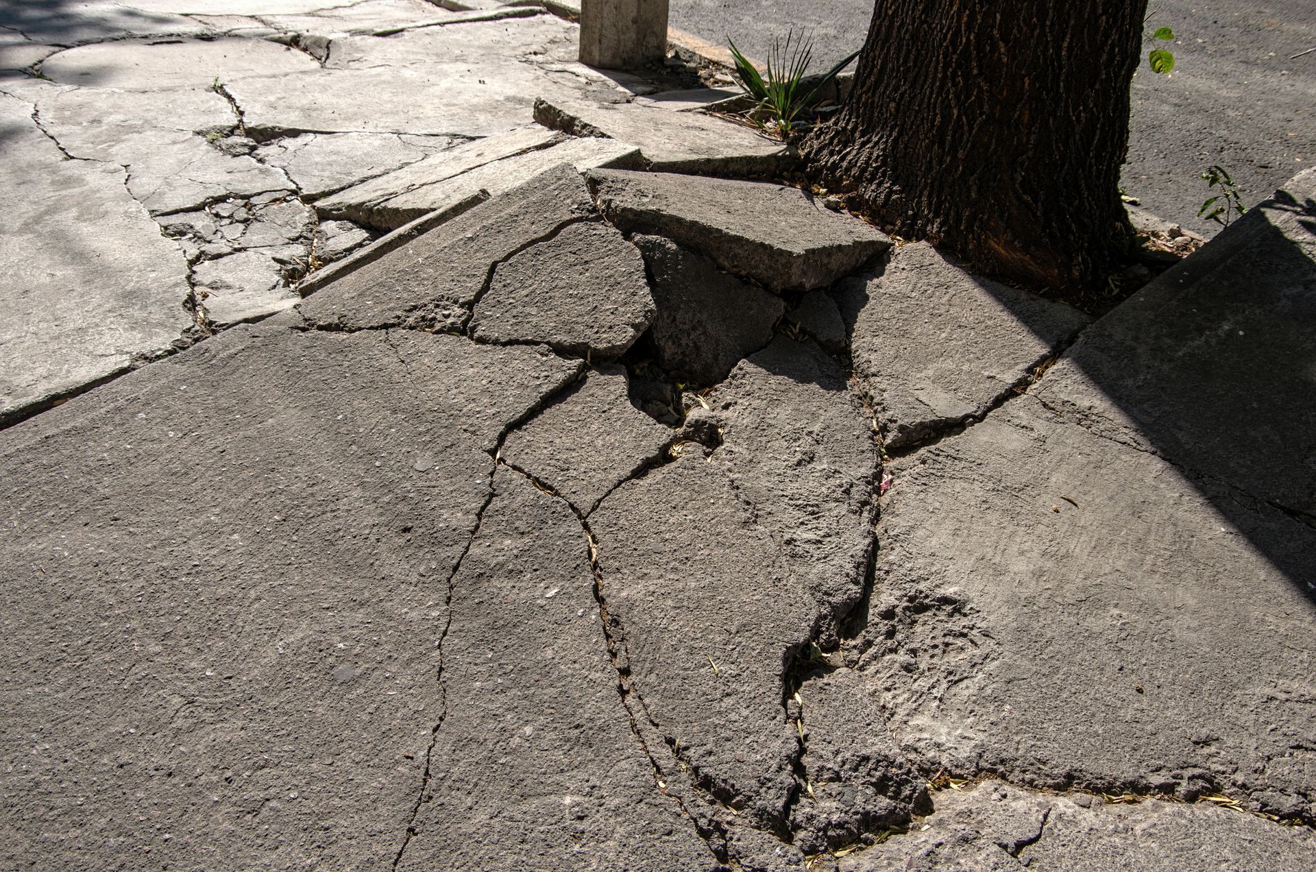 A person is spreading adhesive on a tile floor with a trowel.
