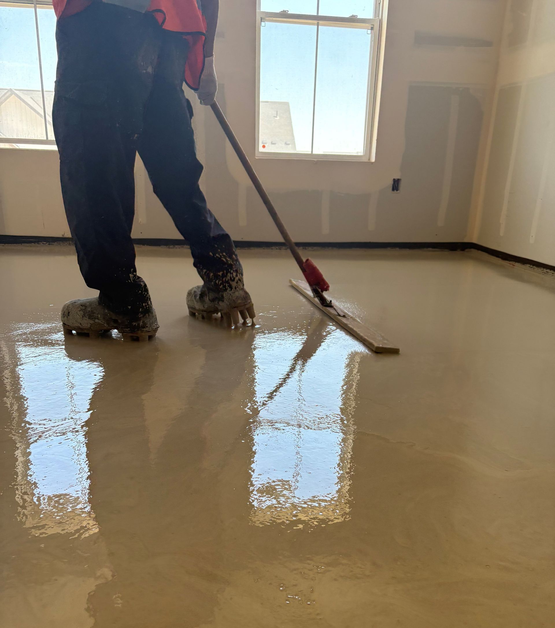 A large empty building under construction with a concrete floor.