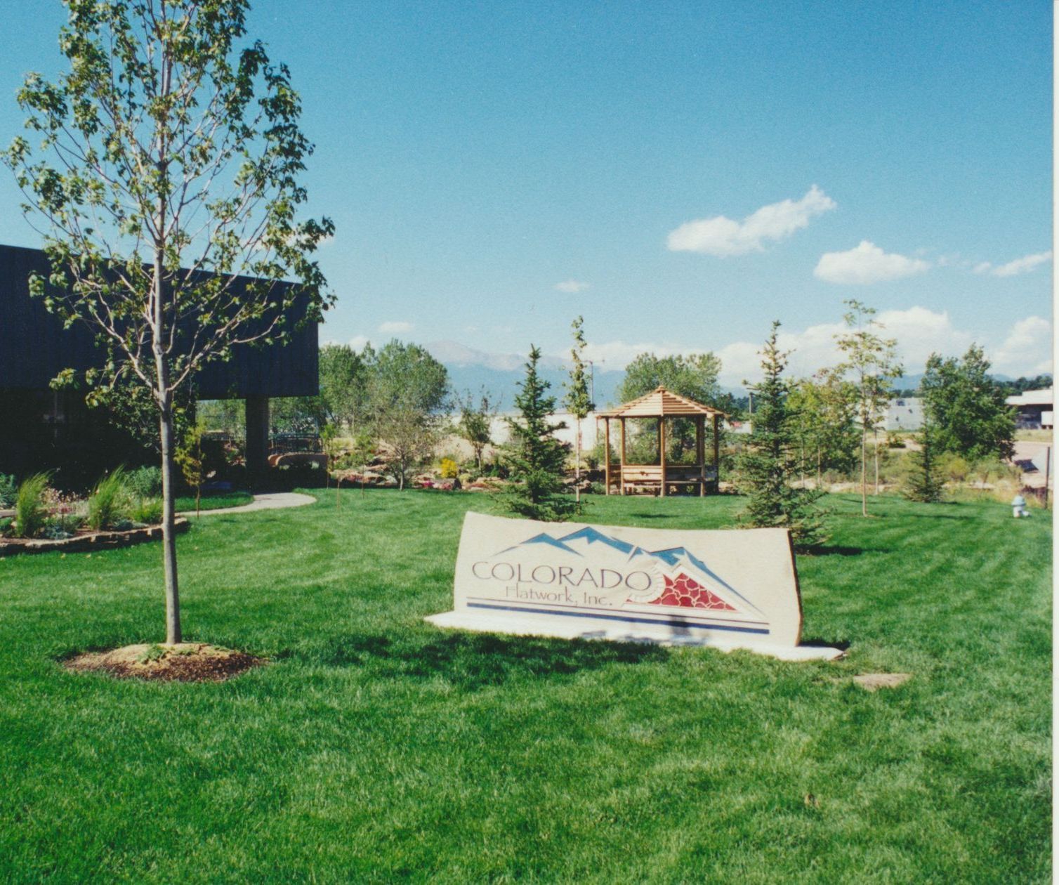 A man is pouring concrete into a bucket on the floor.