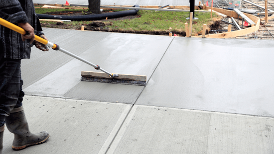 Concrete professional finishing up leveling a driveway in MN