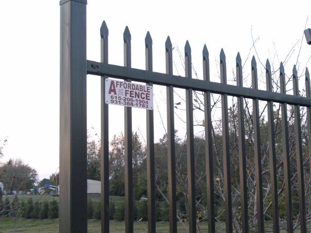 Black metal security fence with pointed pickets and an 