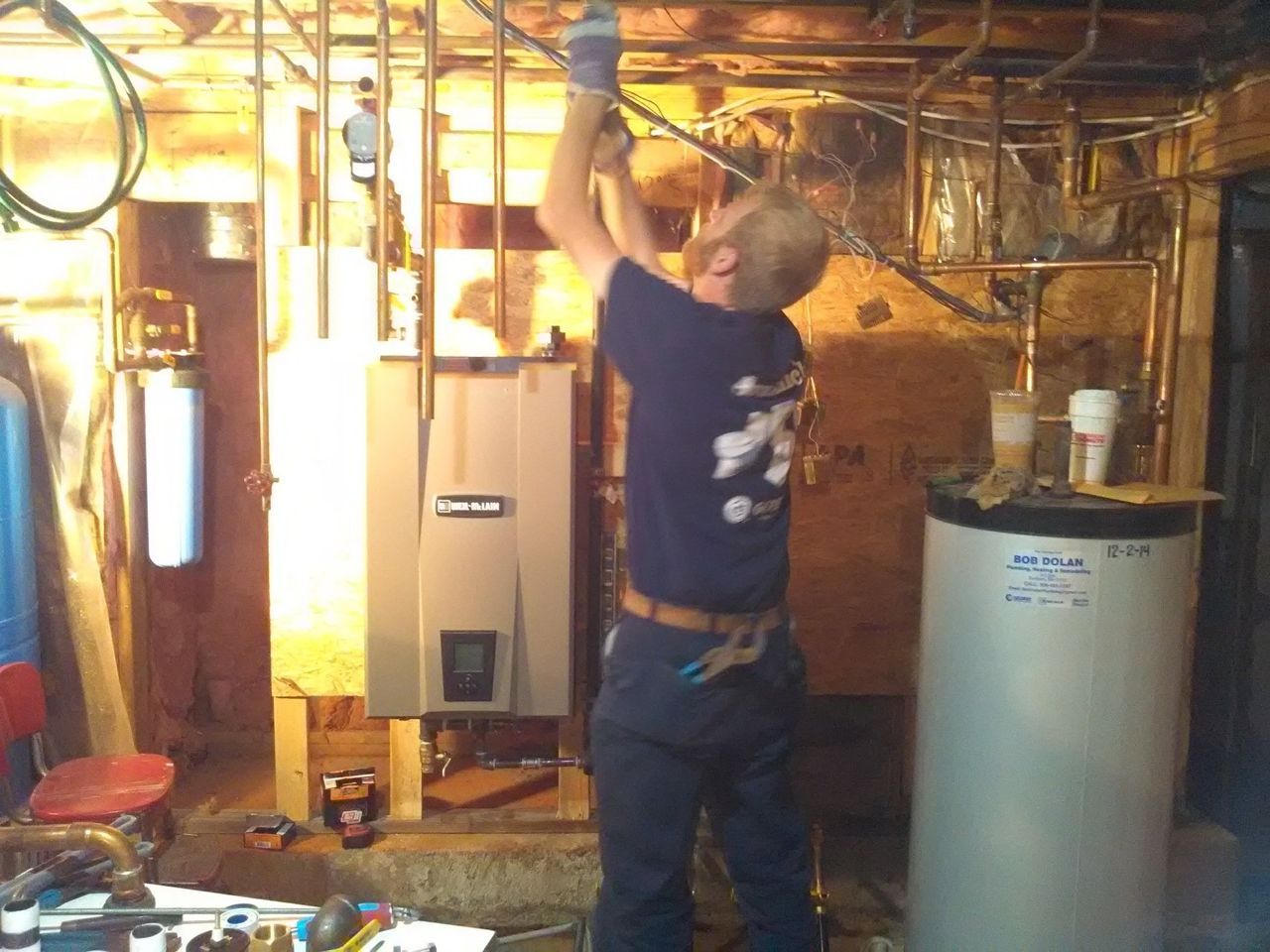 Man Repairing a Water Heater — Marlborough MA  — Bob Dolan Plumbing, Heating & Remodeling
