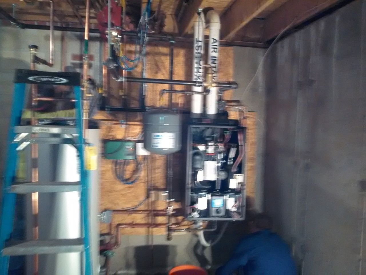 Water Heater Beside a Power Breaker — Marlborough MA  — Bob Dolan Plumbing, Heating & Remodeling
