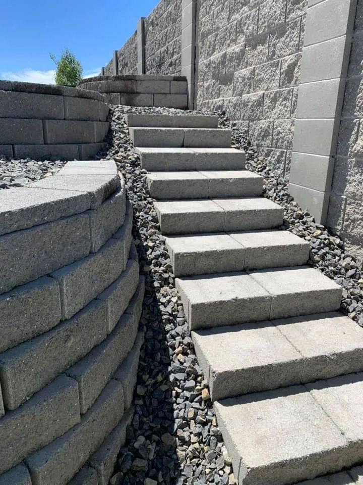 A set of stairs leading up to a brick wall.