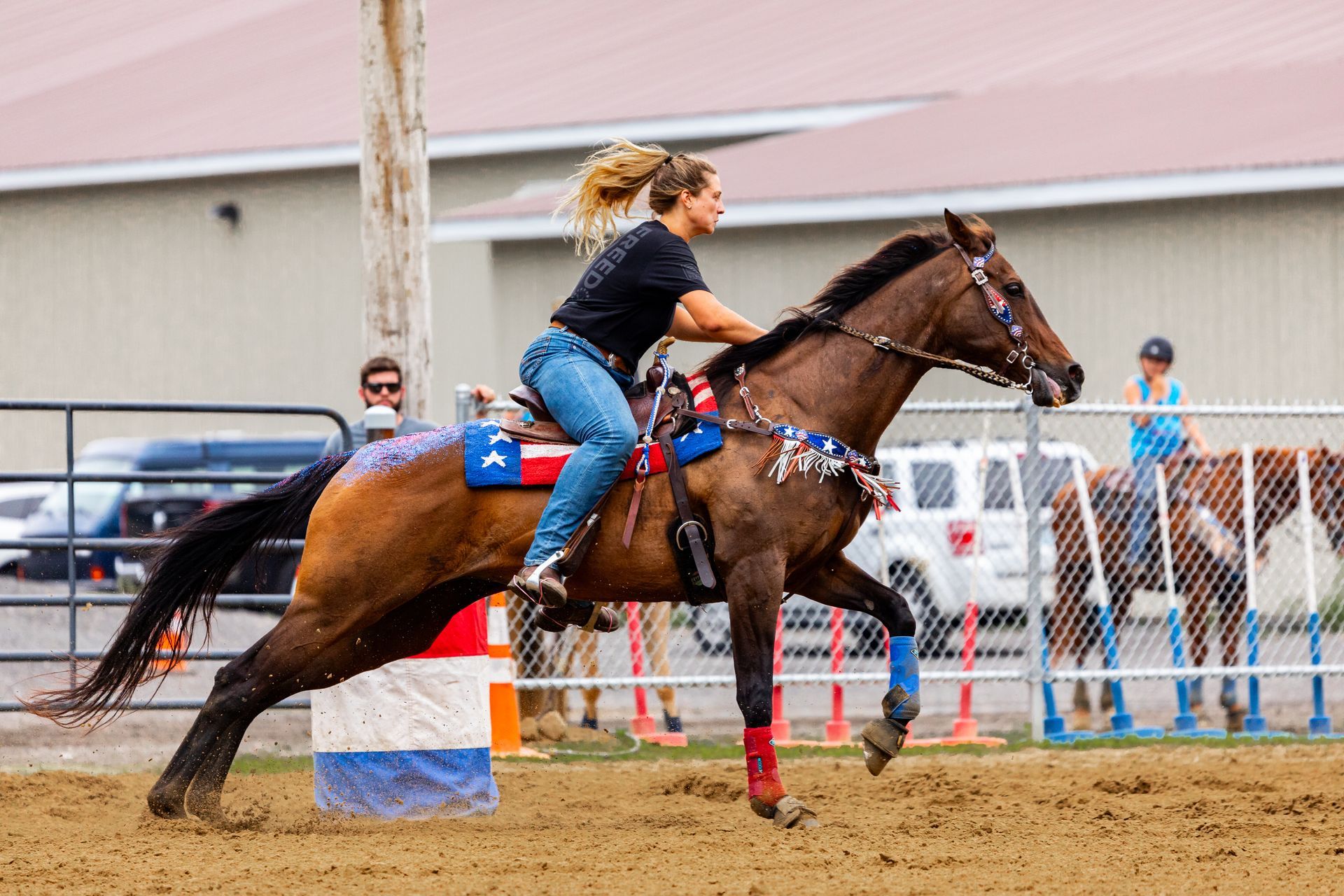 A woman is riding a horse in a rodeo.