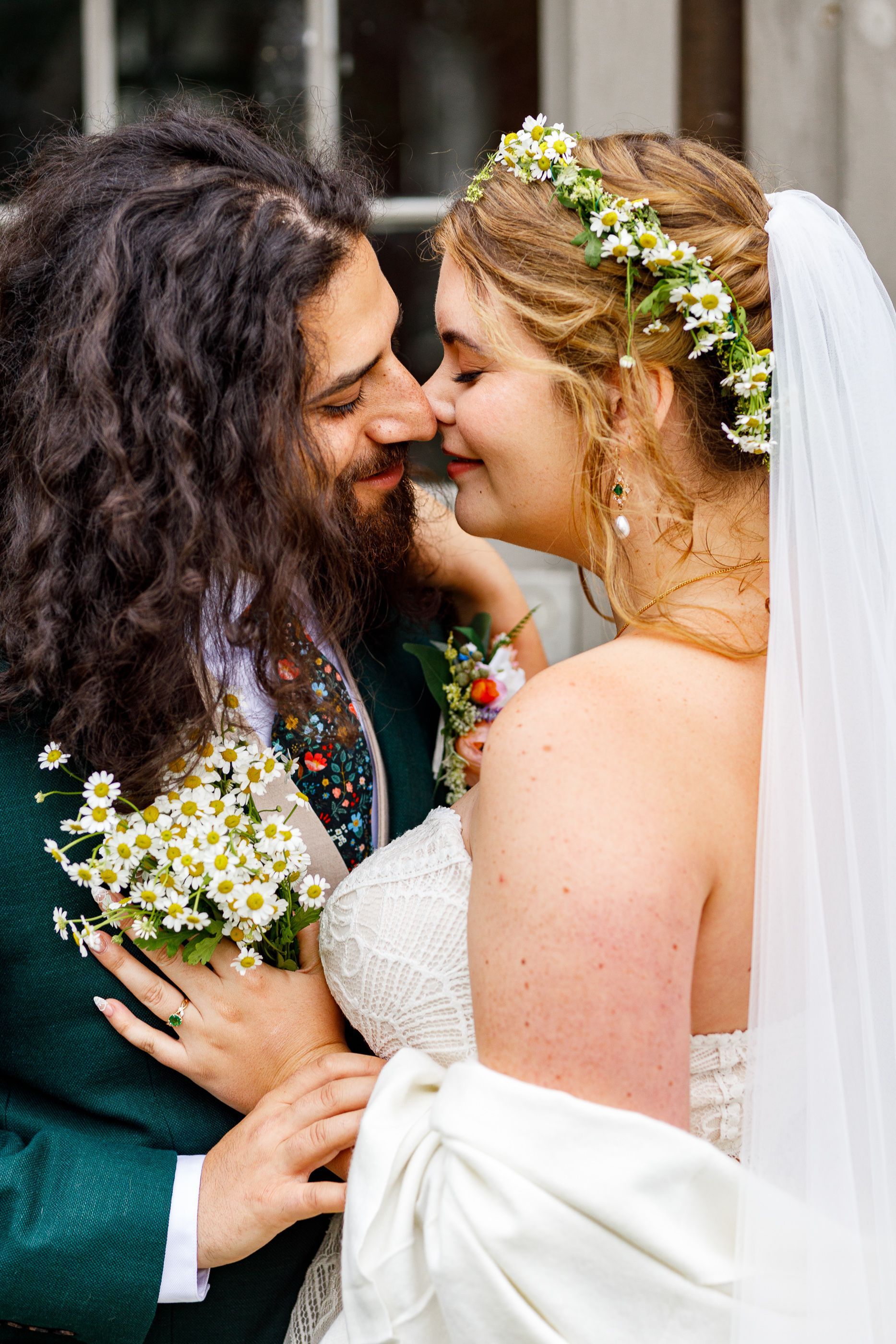 A bride and groom pre-kiss in a loving embrace