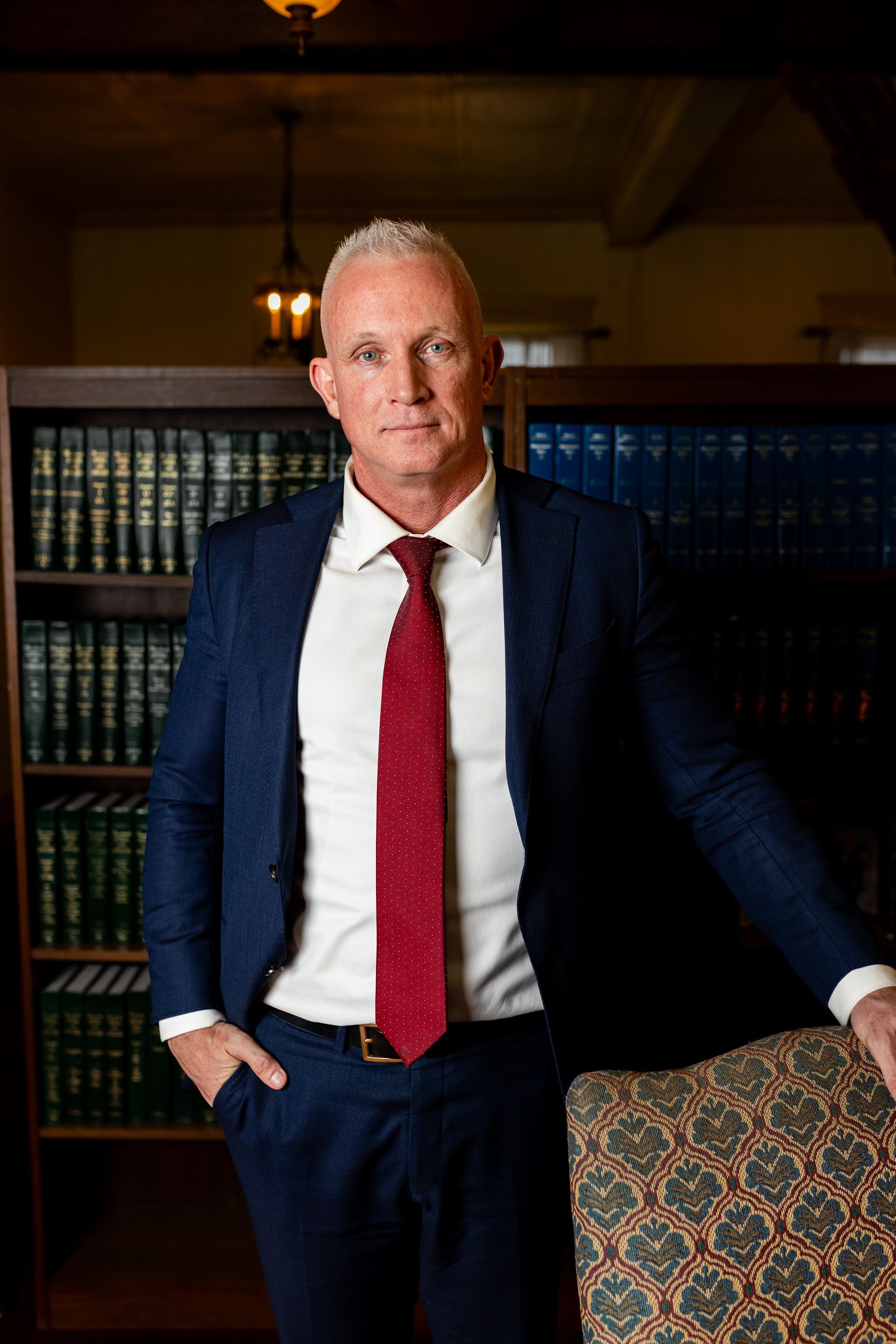 Business portrait man in a blue suit white shirt and red tie