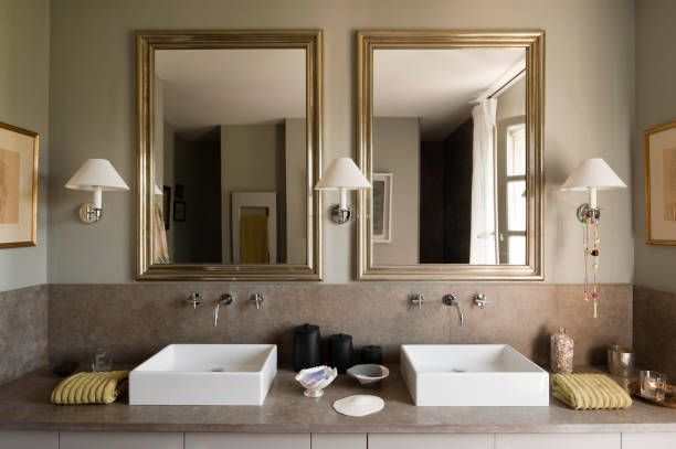 A bathroom with two sinks and two mirrors
