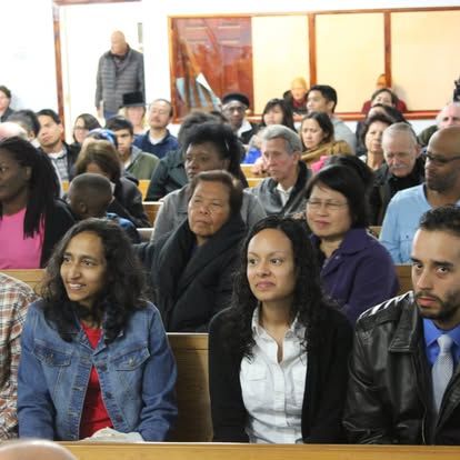 A large group of people are sitting in a church