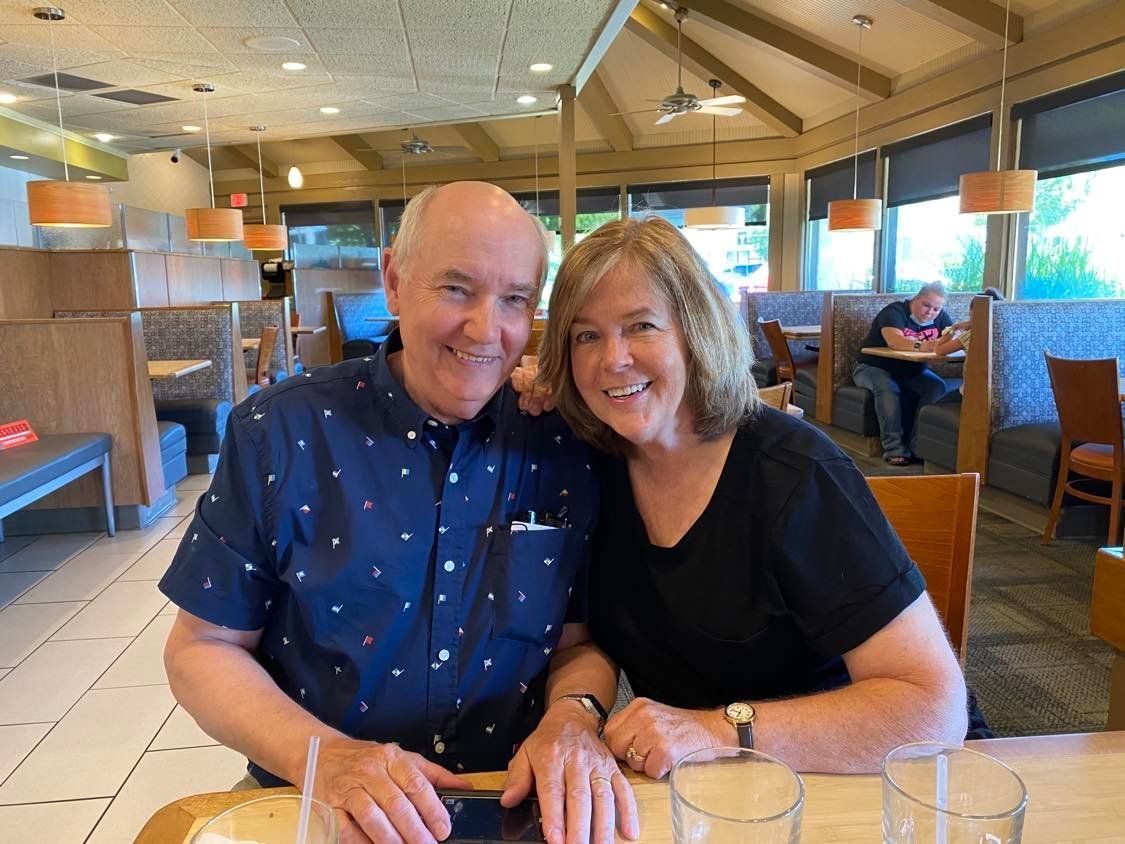 A man and a woman are sitting at a table in a restaurant.